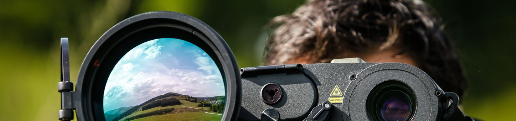 Operator using an optical surveillance scope